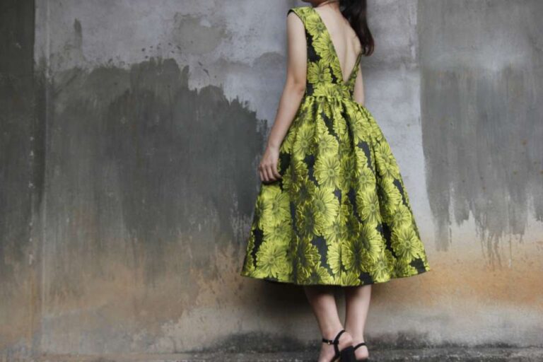 mulher perto de uma parede usando vestido amarelo com preto